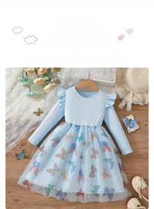 Detail of light blue girls dress with butterfly tulle skirt on wooden hanger