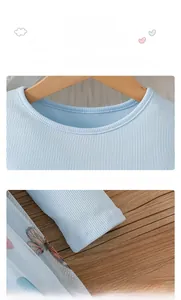 Detail of light blue ribbed fabric dress with round neck and elastic cuffs for girls