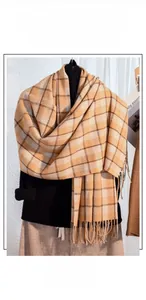 Detail of checkered plaid scarf with yellow and brown fibers and soft fringe edges