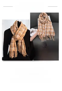 Close-up of orange and beige checkered scarf featuring dense fringe and thick texture