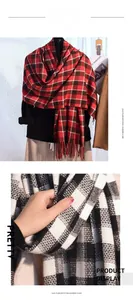 Detail of red and black check imitation cashmere scarf with soft tassel trim for winter