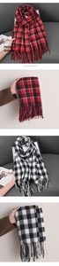 Detailed view of checkered cashmere scarves with classic fringe and soft plaid patterns