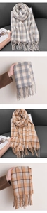 Close-up detail of soft plaid scarf with tassels in grey-beige and orange-beige shades