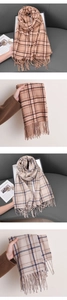 Detail of soft checkered scarf with fringe in orange-brown and beige-grey colors