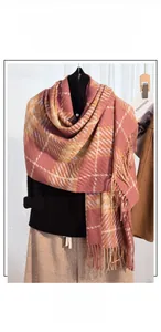 Close-up of pink houndstooth faux cashmere scarf with fringe details on a mannequin