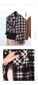 Detail of black and white plaid imitation cashmere scarf with soft fringes and texture
