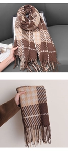Detail of coffee houndstooth cashmere scarf showing thick twill weave and fringe tassels