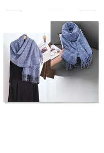 Detail of navy blue plaid scarf with orange accents and thick fringe texture