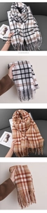 Macro shot of plaid cashmere-like scarf with thick fringe and soft texture display