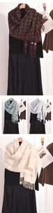 Detailed view of color-blocked plaid knit scarves with fringe in four autumn shades