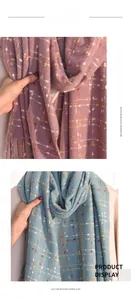 Detailed texture of lilac and blue plaid imitation cashmere scarf with soft fringe trim