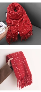 Macro detail of red plaid cashmere-like scarf with soft texture and fringe edges