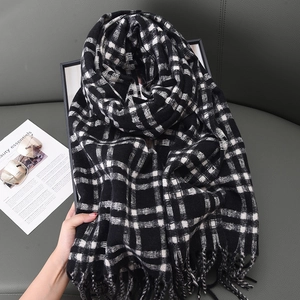 Classic black and white checkered scarf with fringe tassels made of thick warm knit