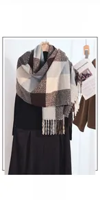 Detail of checkered cashmere-feel scarf with tassels in brown, blue and beige tones