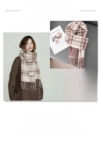Detail shot of a brown plaid cashmere scarf with fringes showing warm soft texture