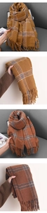 Close-up of thick checkered scarf fabric with soft texture and classic fringe tassels