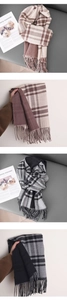 Detail of plaid imitation cashmere scarves with long fringe tassels in brown and grey tones