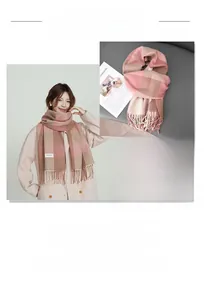 Detail of pink and brown plaid scarf featuring long tassels and soft cashmere texture