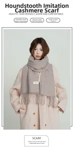 Detail of coffee houndstooth cashmere scarf with soft tassels on beige coat