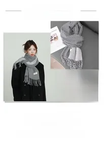 Detail of winter scarf showing thick houndstooth pattern and soft fringe tassels