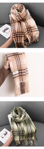 Close-up of thick plaid scarves with tassels in beige and green color options