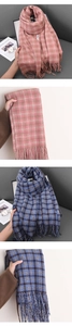Detailed view of pink and blue plaid scarf fringe and soft cashmere-like fabric texture
