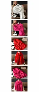 Close-up of pleated cashmere-like scarf with fringe detail in white, rose, and red colors