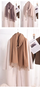 Detailed view of soft cashmere-feel scarves with tassels in beige, camel and purple grey