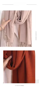 Detail of soft pink and caramel imitation cashmere scarves with classic tassel edges