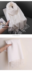 Detail of white imitation cashmere scarf showing soft texture and elegant fringe edges