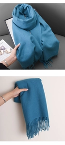 Detail of soft royal blue winter shawl with decorative fringe tassels for women