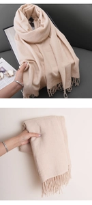 Close-up of soft beige cashmere-feel scarf featuring delicate fringe details and thick texture
