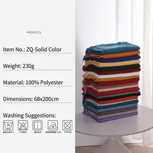 Stack of colorful cashmere-feel scarves with fringe in assorted winter fashion shades