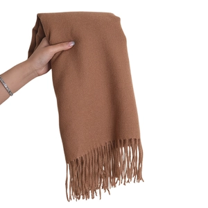 Soft brown cashmere-like scarf with fringe details shown held in hand for drape