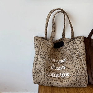 Detailed texture of leopard print suede tote bag with May your dreams come true text