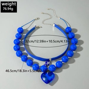 Blue double-layer necklace set with heart pendant and large beads against grey background
