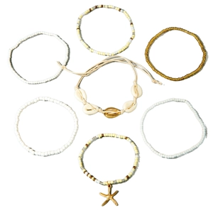 Bohemian 7-piece anklet set with white and gold beads, natural shells, and a starfish charm
