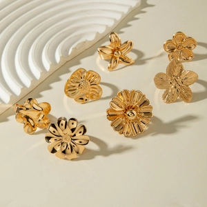 Set of seven vintage French gold flower rings with various elegant floral petal designs