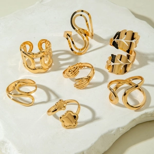Polished gold adjustable ring set with floral leaf and wave patterns on stone base