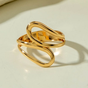 Close-up of abstract golden hollow ring with sleek metal lines and mirror finish