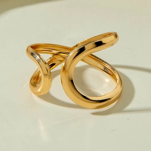 Macro detail of a gold minimalist twisted geometric ring with sleek artistic curves