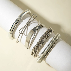 Five-piece silver multilayered punk bangle set featuring curved tubes and cuban link chain