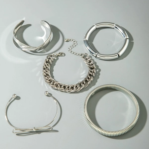 Detailed view of 5-piece silver punk stackable bracelet set with metal tubes and Cuban links