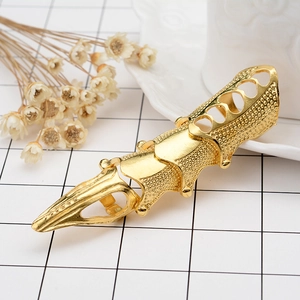 Detailed view of golden punk armor ring featuring heart cut-outs and hinged joints