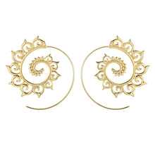 Detailed close-up of golden spiral earrings featuring bohemian hollow carved leaf patterns