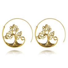 Detail of vintage gold tree of life hoop earrings with intricate spiral leaf design