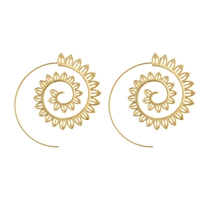Detailed macro view of golden spiral leaf earrings with vintage ethnic pattern