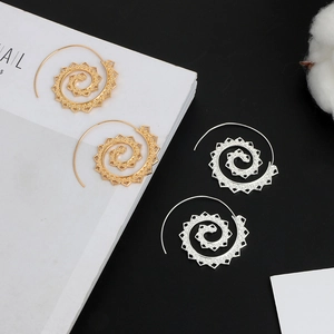 Detailed view of hollow spiral oval earrings in gold and silver with vintage swirl patterns