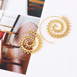 Detailed view of bohemian golden spiral leaf earrings with intricate mandala patterns