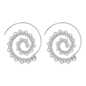 Detailed macro of silver spiral earrings with ethnic hollow lotus flower patterns